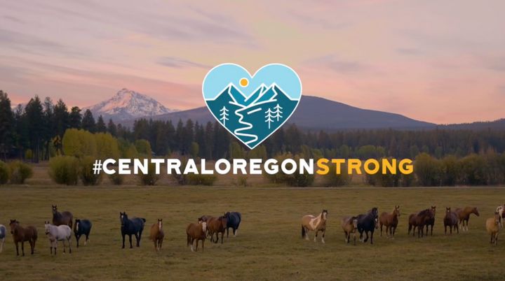 A blurred photo of horses grazing in a scenic meadow is overlaid with the text: #CentralOregonStrong.