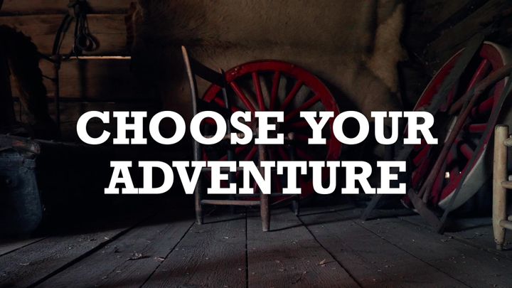 A still from the Choose Your Adventure video series picturing a wagon wheel inside a dusty barn. Title card text displays the words: Choose Your Adventure.