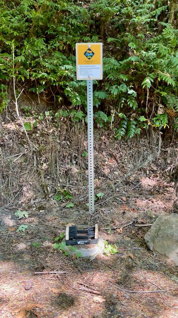 A sign marks the location of a boot scrubbing station.