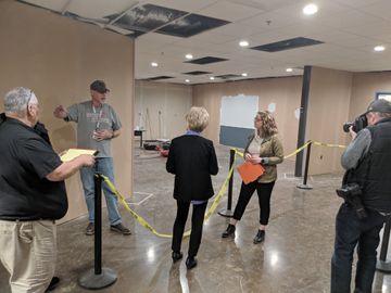 A contractor explains details of the Carousel Museum renovations. Behind, the partially-completed renovations can be seen.
