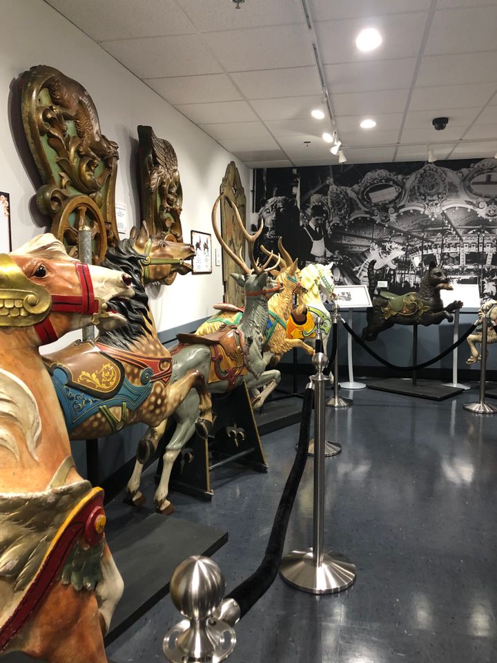 A row of antique carousel ornaments are displayed in the newly-renovated museum space.