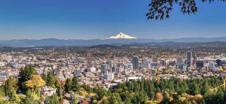 An aerial view of the City of Portland with views of a snow-covered Mt. Hood to the East.